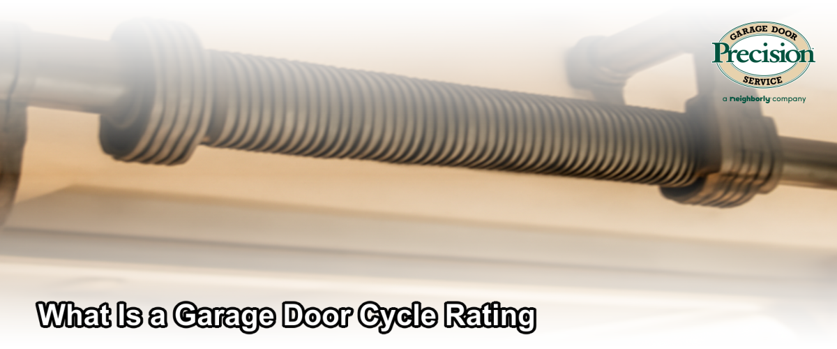 Close-up of a garage door spring and hardware assembly with a clean residential garage in the background, representing cycle life and durability