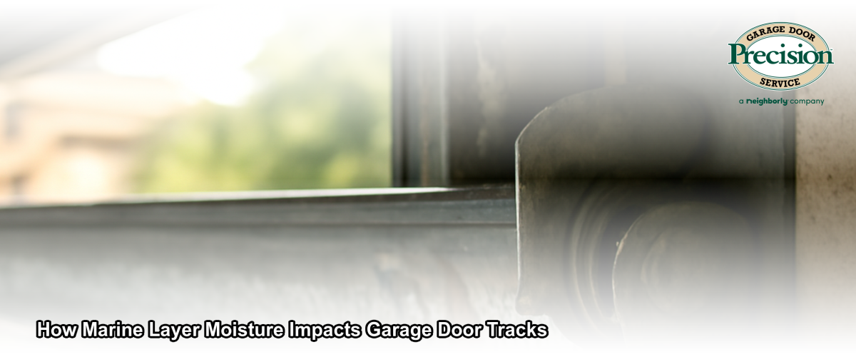 Close-up of a garage door track showing early rust and moisture buildup in a coastal California home garage
